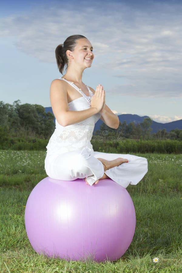 Young brunette girl performing yoga