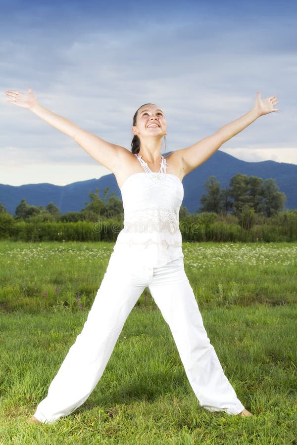 Young brunette girl performing yoga