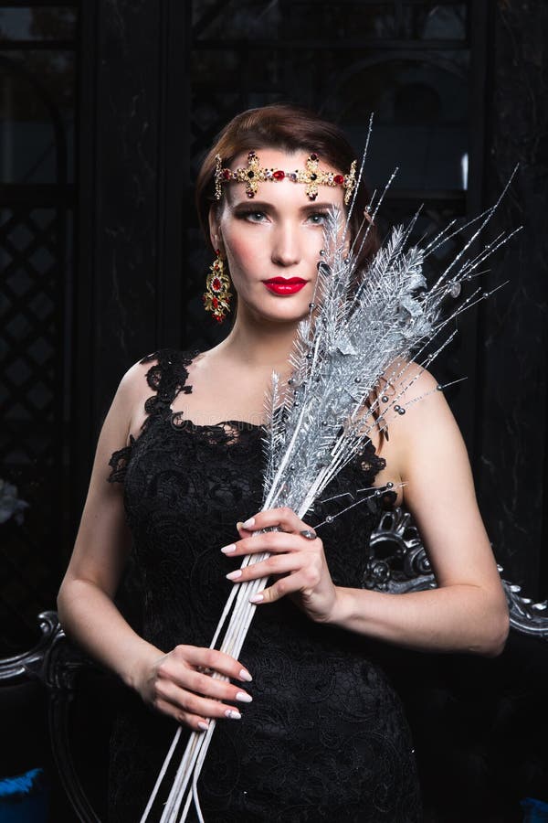 Model in gorgeous outfit with silver decor stock photo