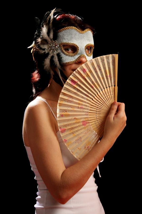 Young brunette with venetian mask and spanish fan