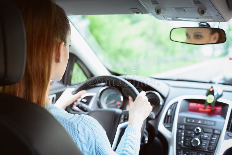 Young brunette woman driving a car