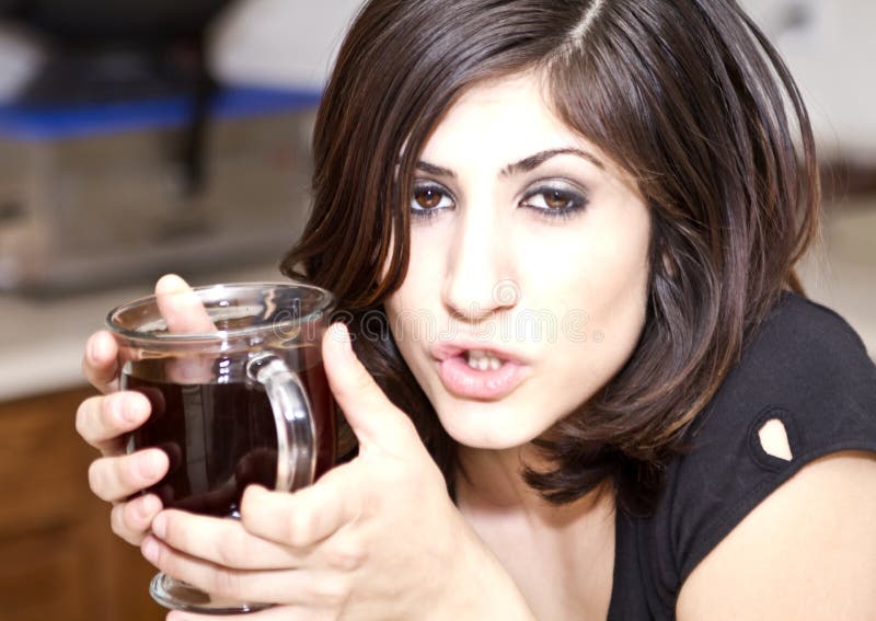 Young Brunette Woman Enjoys Her Coffee