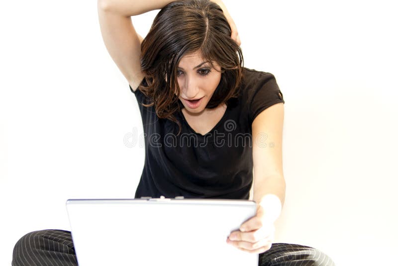 Young Brunette Woman Finds Surprise on Computer stock photo Young Brunette Woman Finds Surprise on Computer stock photo