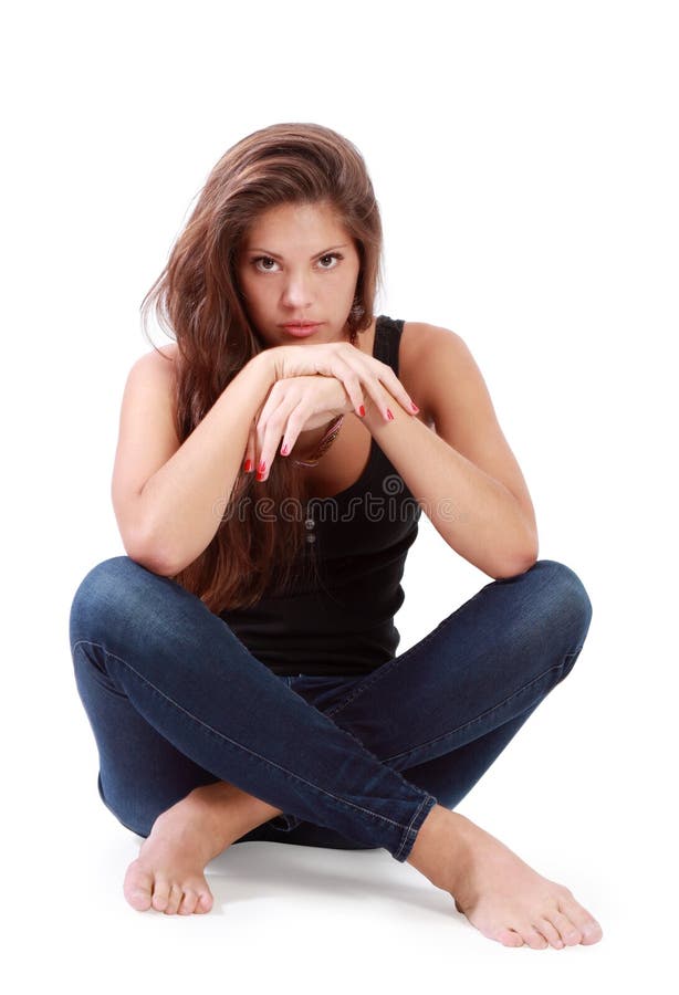 Young Brunette Woman Sits On Floor With Bended Knees Stock Image