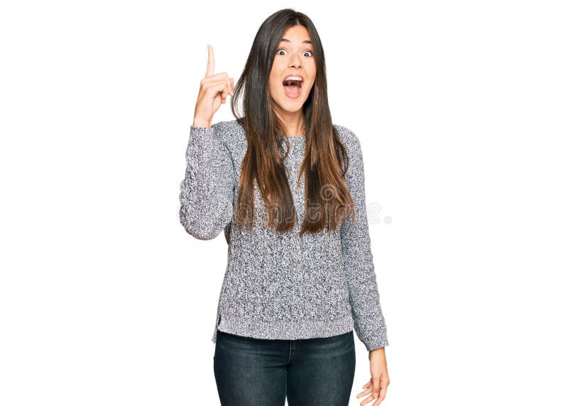 Young brunette woman wearing casual winter sweater pointing finger up with successful idea