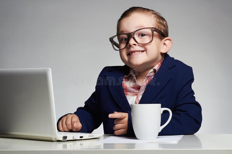 Young business boy. smiling child in glasses. little boss in office. funny kids