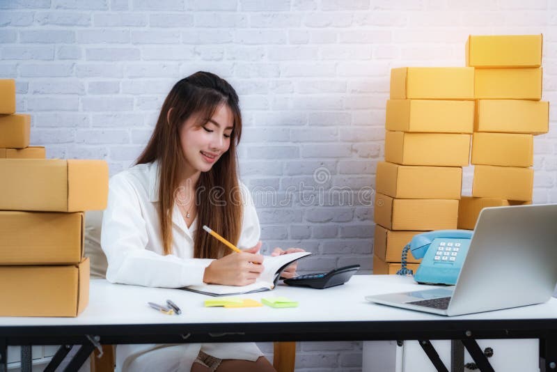 Young business entrepreneur owner write in the delivery in notebook about online delivery business. online shopping SME stock images Young business entrepreneur owner write in the delivery in notebook about online delivery business. online shopping SME stock images