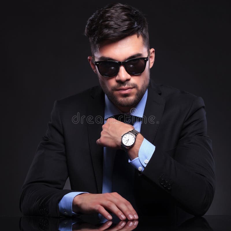Young business man adjusts his tie royalty free stock photography