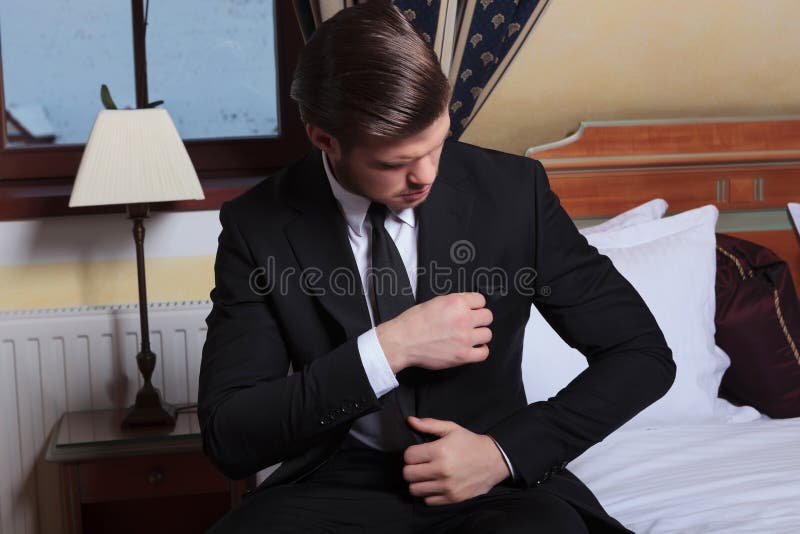 Young business man adjusts pocket napkin royalty free stock photography