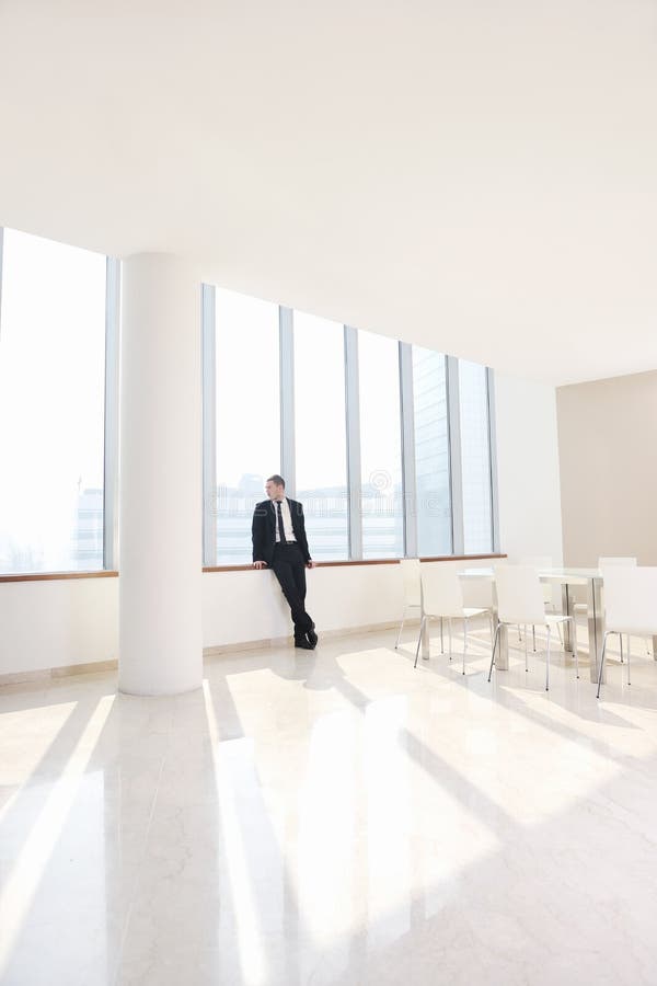 Young business man alone in conference room