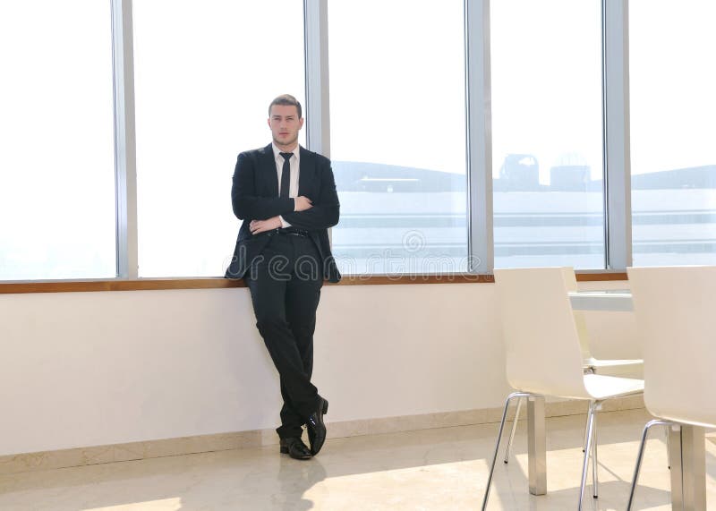 Young business man alone in conference room