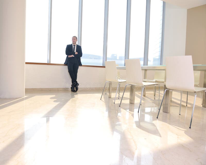 Young business man alone in conference room