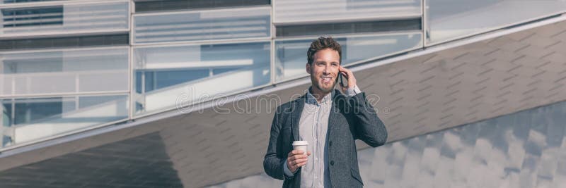 Young business man calling talking on the mobile phone on coffee break from office building outside. Businessman walking on street commute lifestyle.