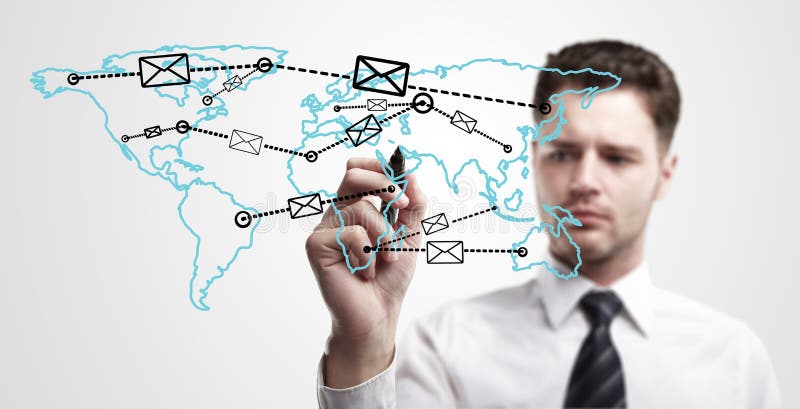 Young business man drawing a global network with envelopes on world map. Man drawing E-mail Icon on a glass window. The metaphor of international communication around the world. On a gray background. Global network connection map stock images, royalty-free photos and pictures