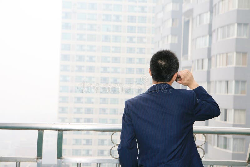 Young business man holding mobile phone