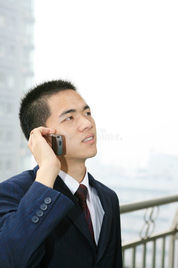 Young business man holding mobile phone