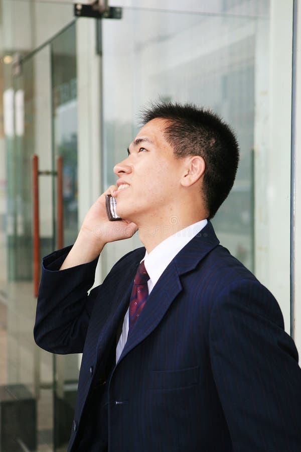 Young business man holding mobile phone