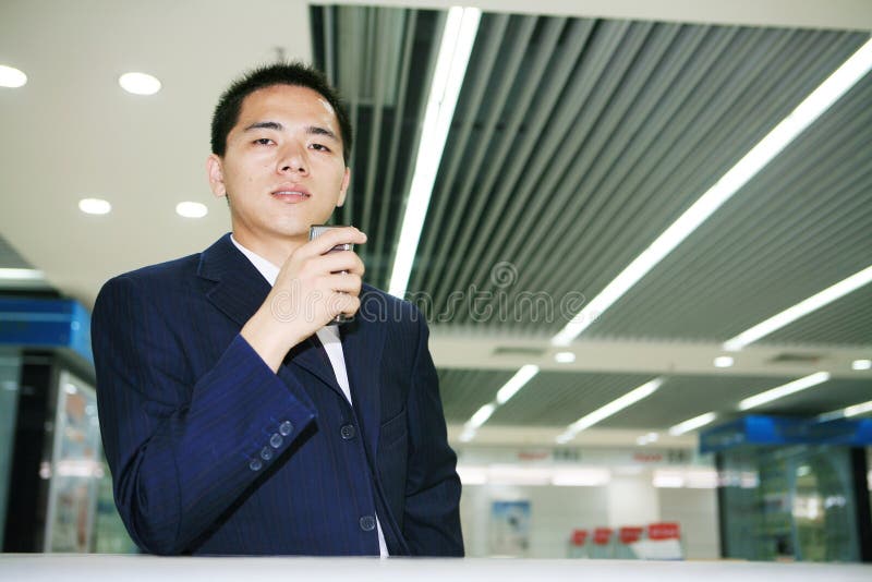 Young business man holding mobile phone