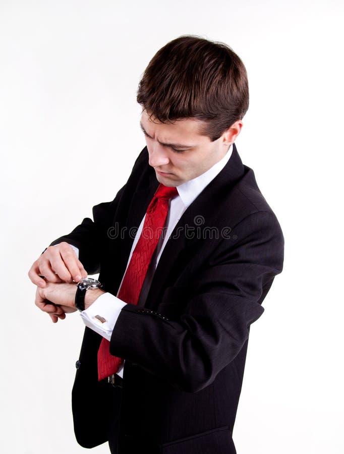 Young business man looking on his watch stock photo