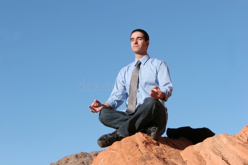 Young business man meditating