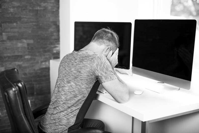 Young business man with problems and stress in the office royalty free stock photos Young business man with problems and stress in the office royalty free stock photos