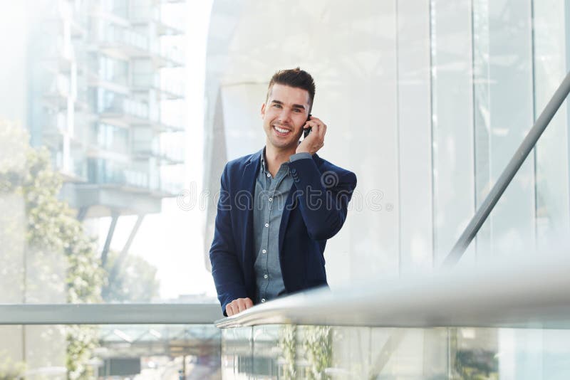 Young business man smiling with mobile phone