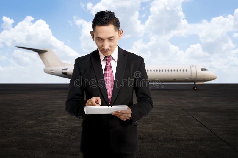 Young business man using his tablet on the airport stock images Young business man using his tablet on the airport stock images