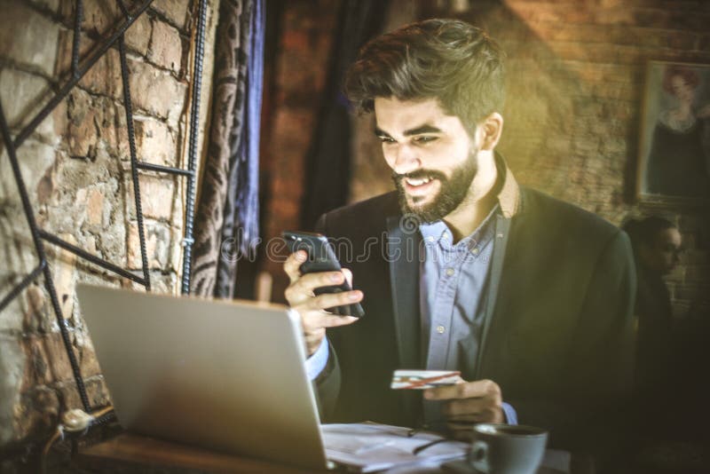 Young business man using smart phone to pay bills online. stock photography Young business man using smart phone to pay bills online. stock photography