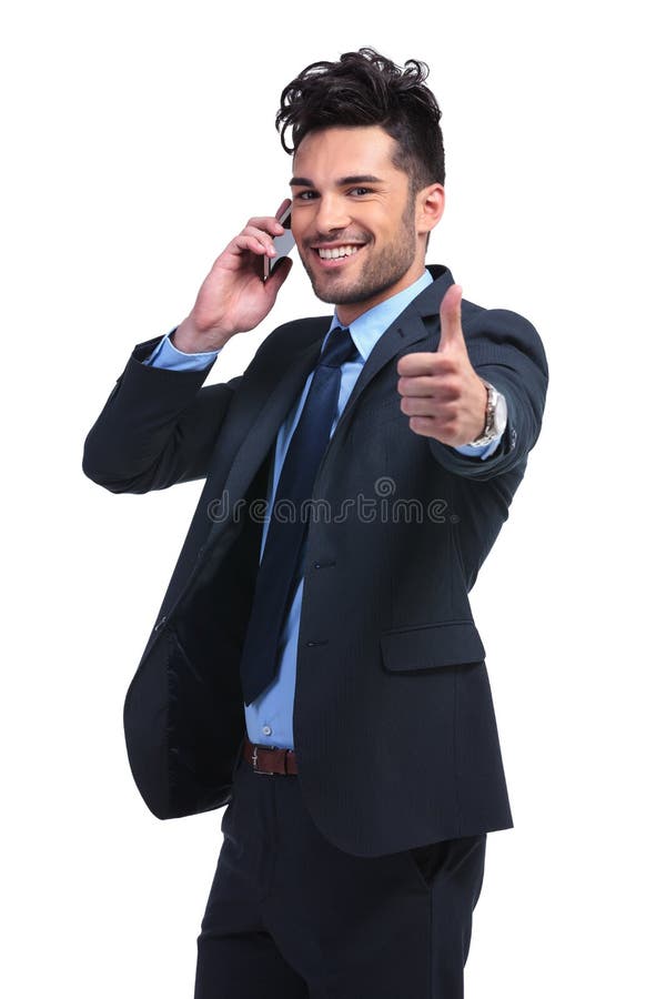 Young business man with very good news on the phone