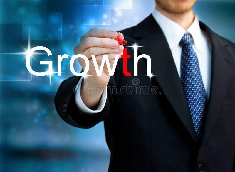 Young business man writing the word Growth stock image Young business man writing the word Growth stock image