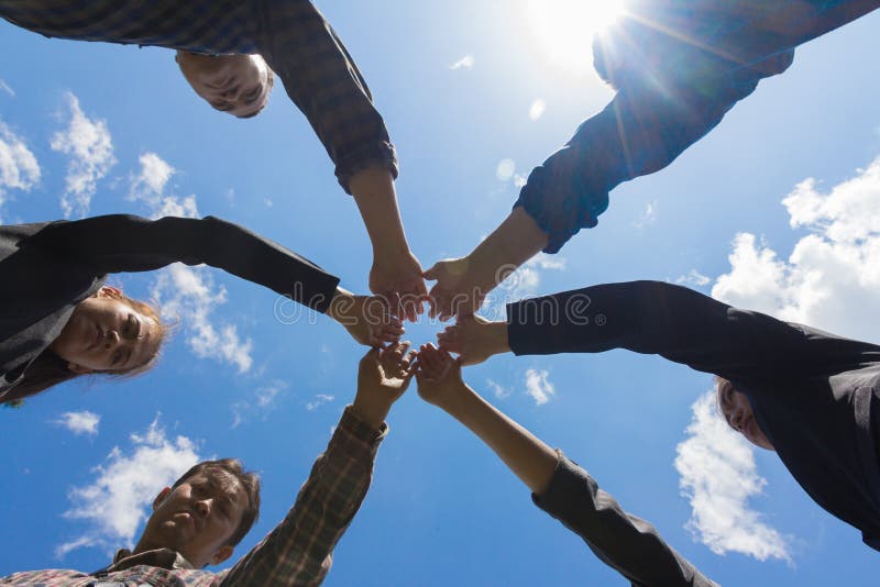 Young business people putting their hands together, Sky backgrou royalty free stock photo Young business people putting their hands together, Sky backgrou royalty free stock photo