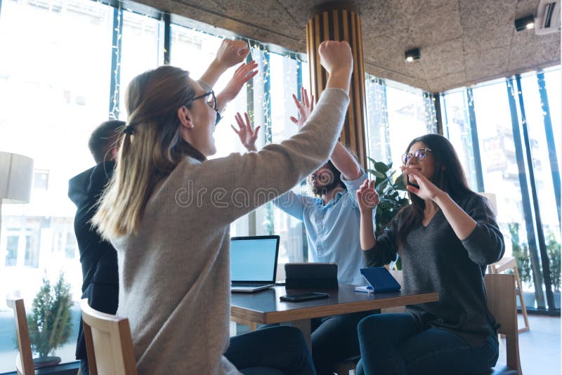 Young business people talking with each other about new projects at a coffee bar. Success and togetherness concept. stock photography Young business people talking with each other about new projects at a coffee bar. Success and togetherness concept. stock photography