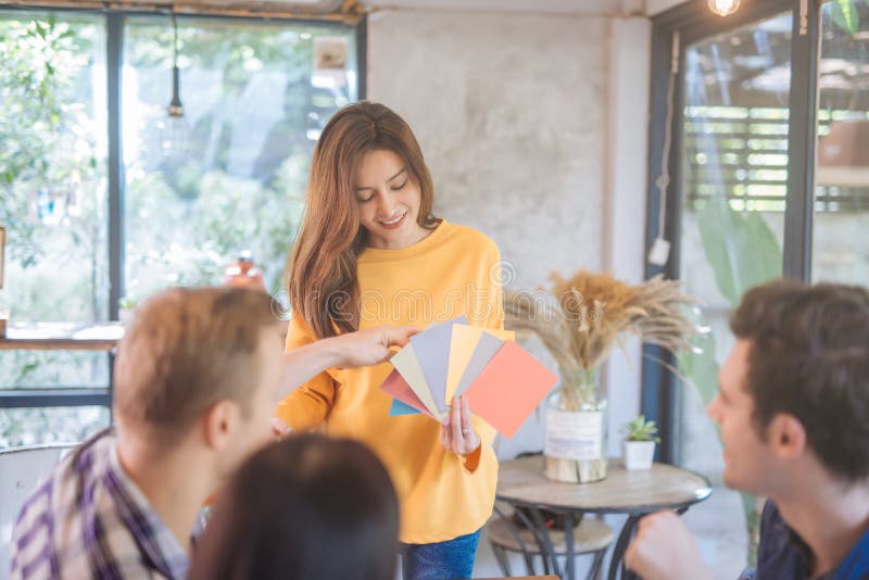 Young business people and. team designers working with color palette. Asian model choosing color sampling on new project. . stock photography