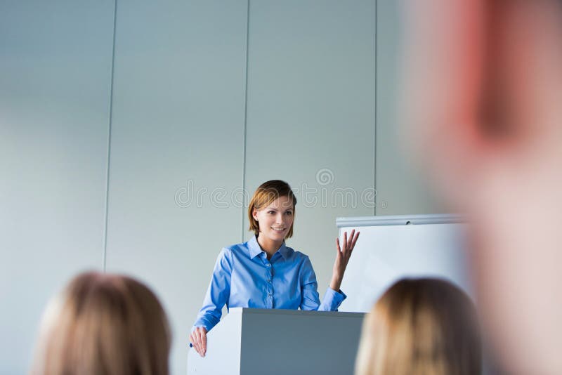 Young business speaker gesturing while standing in conference room royalty free stock photos Young business speaker gesturing while standing in conference room royalty free stock photos
