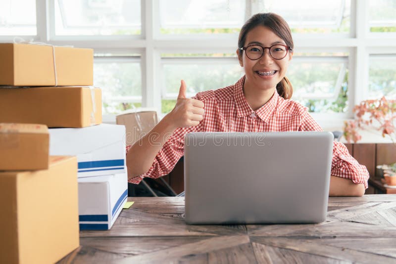 Young business start up online seller owner using computer for checking the customer orders from email or website and preparing royalty free stock image Young business start up online seller owner using computer for checking the customer orders from email or website and preparing royalty free stock image
