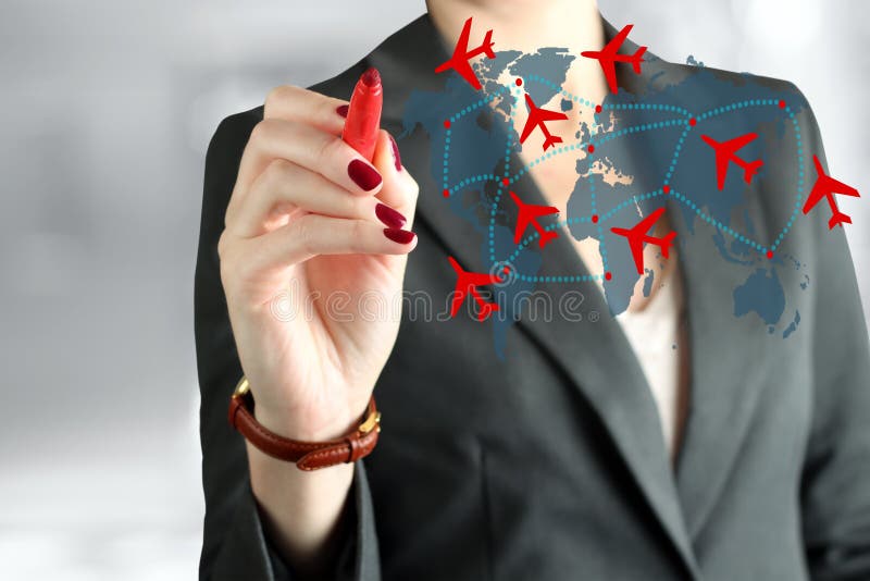 Young business woman drawing an airplane routes on world map. royalty free stock photography Young business woman drawing an airplane routes on world map. royalty free stock photography