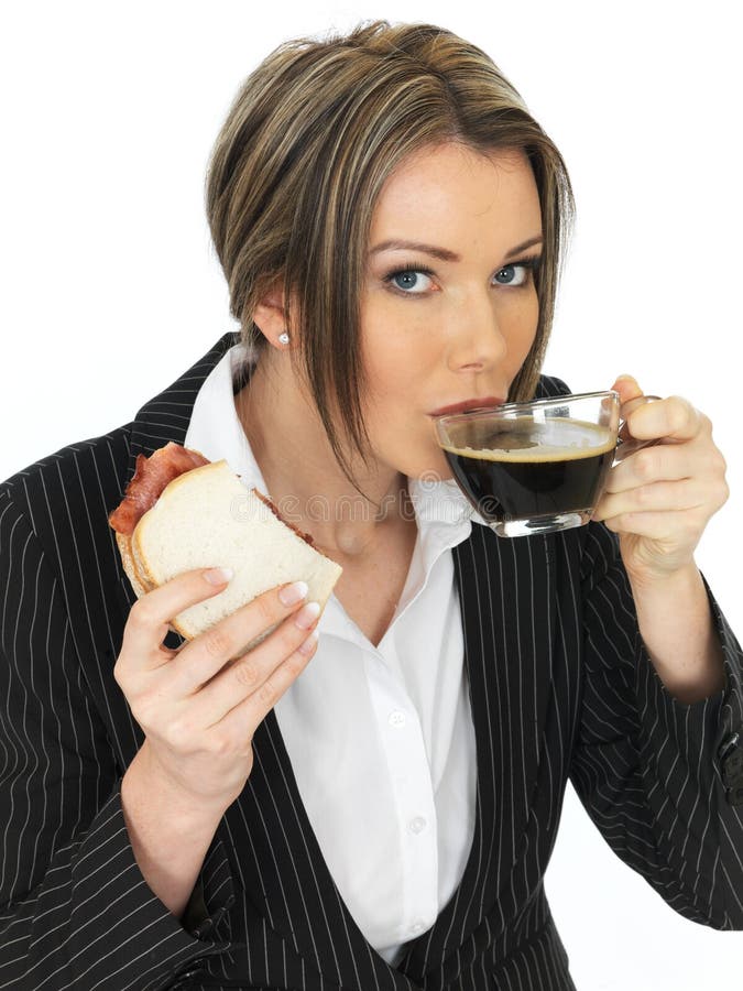 young-business-woman-eating-bacon-sandwi