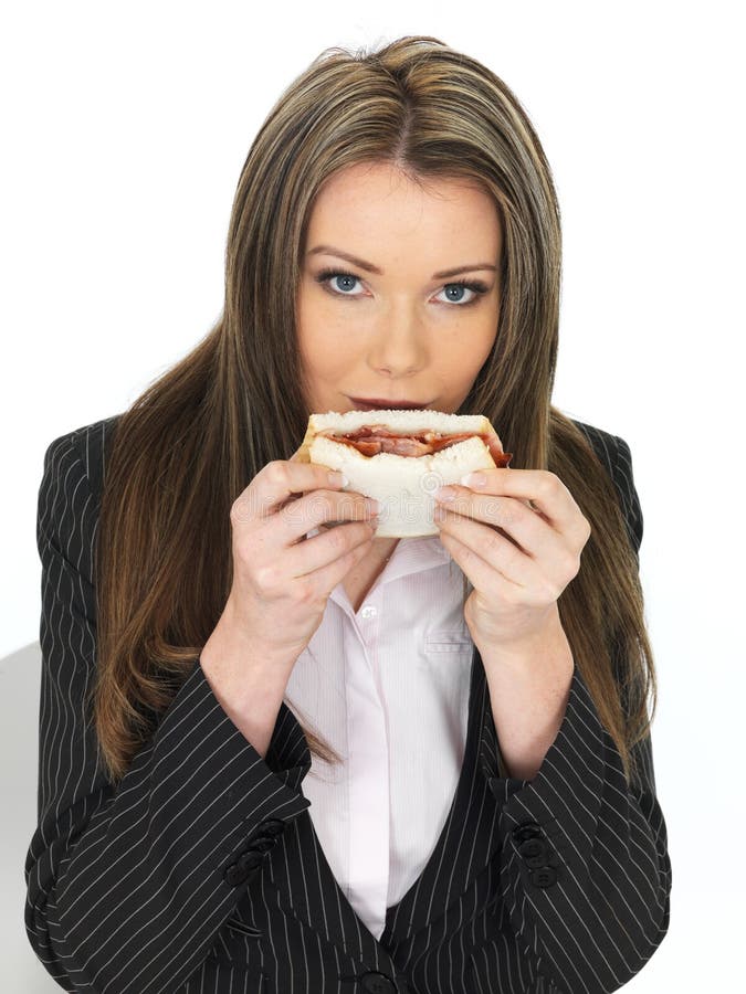 young-business-woman-eating-bacon-sandwi