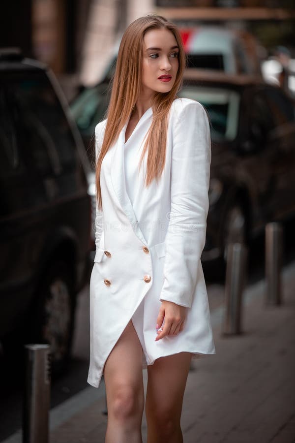 Young business woman outdoors portrait. Soft sunny colors. Close up portrait. beautiful female model wearing at white