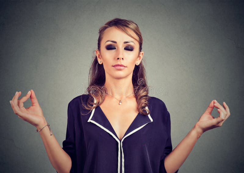 Young business woman meditating with eyes closed stock photo Young business woman meditating with eyes closed stock photo