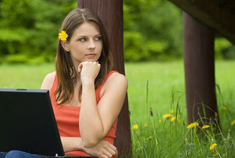 Young business woman relaxing, working on laptop