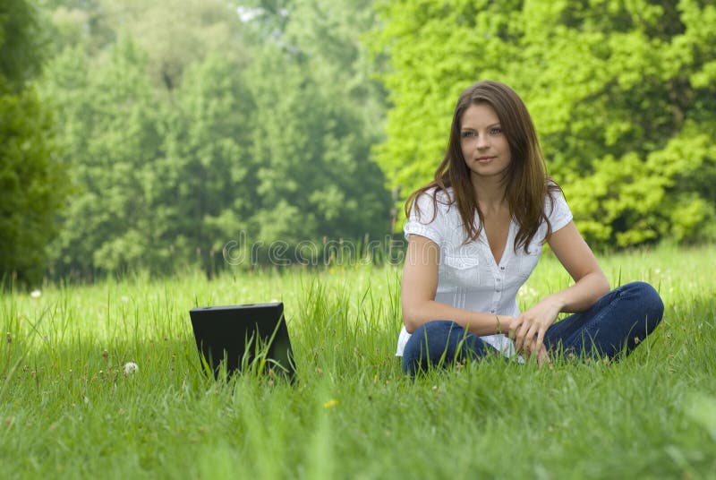 Young business woman relaxing, working on laptop c