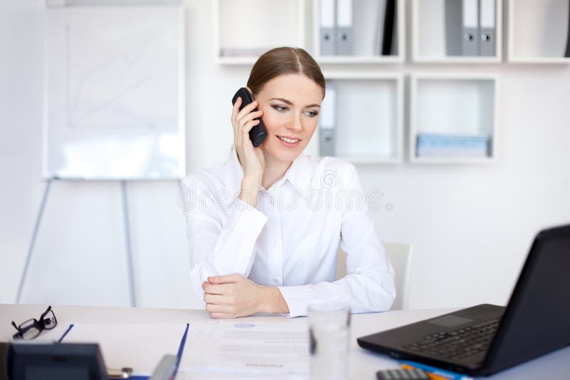 Young business woman talking on cell phone