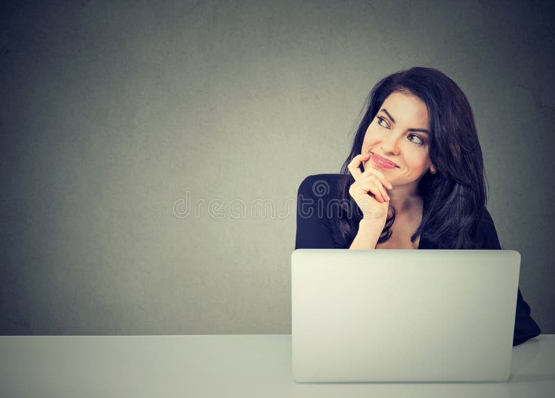 Business woman thinking daydreaming sitting at desk with laptop computer stock photos