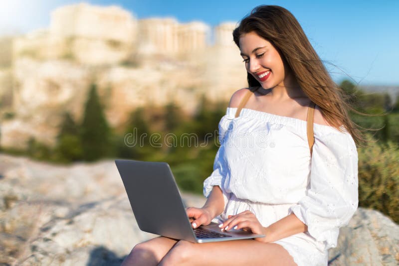 Young business woman working on her laptop outdoors stock image Young business woman working on her laptop outdoors stock image