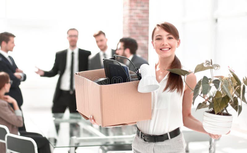 Young business woman with personal things on office background stock photo Young business woman with personal things on office background stock photo