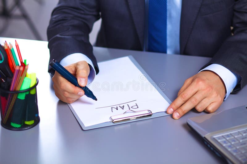 Young businessman behind the desk in the Office