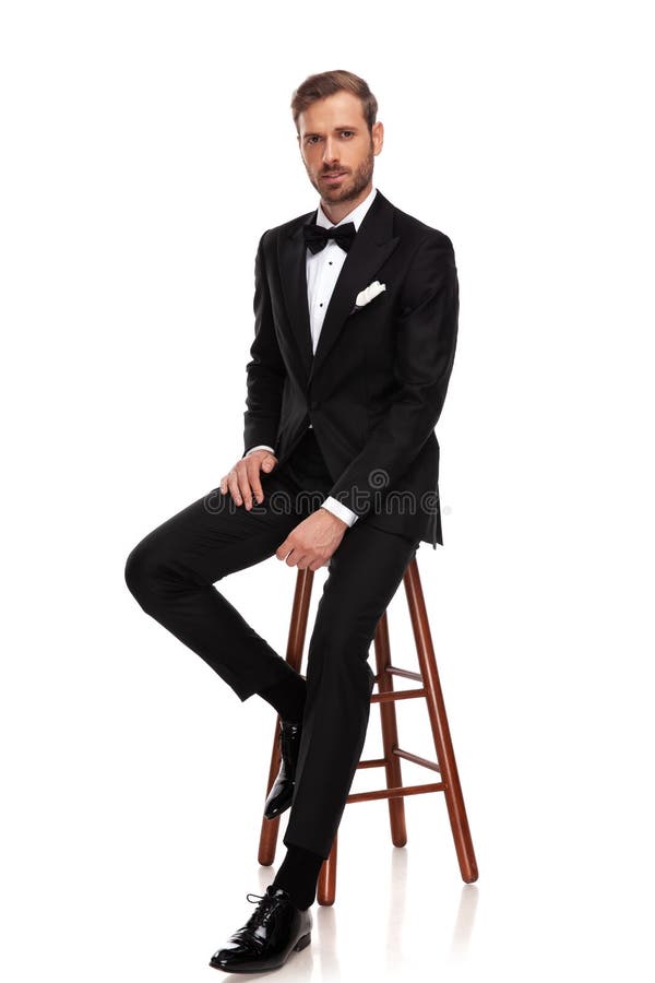 Man in Suit Sitting in Studio with Hands on His Knees Stock Image ...