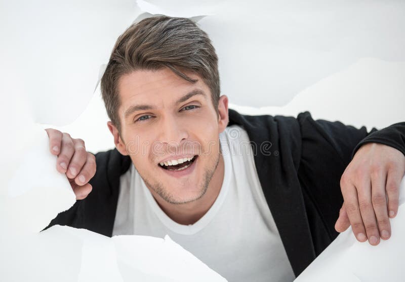 Businessman Breaking Through The Paper Wall And Pointing At You Stock