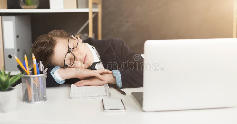 Exhausting work. Little businessman child in business suit get tired and fell asleep at table in office, copy space. Exhausting work. Little businessman child in business suit get tired and fell asleep at table in office, copy space